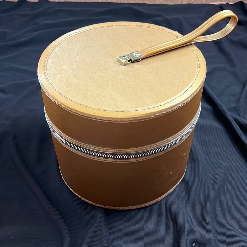 Midcentury wig travel case in goldish bronze